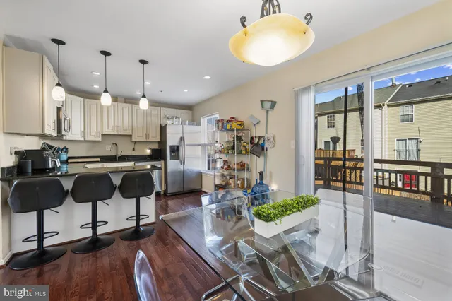 a view of kitchen with dining area refrigerator and window