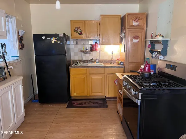 a living room with a stove and a wooden floor