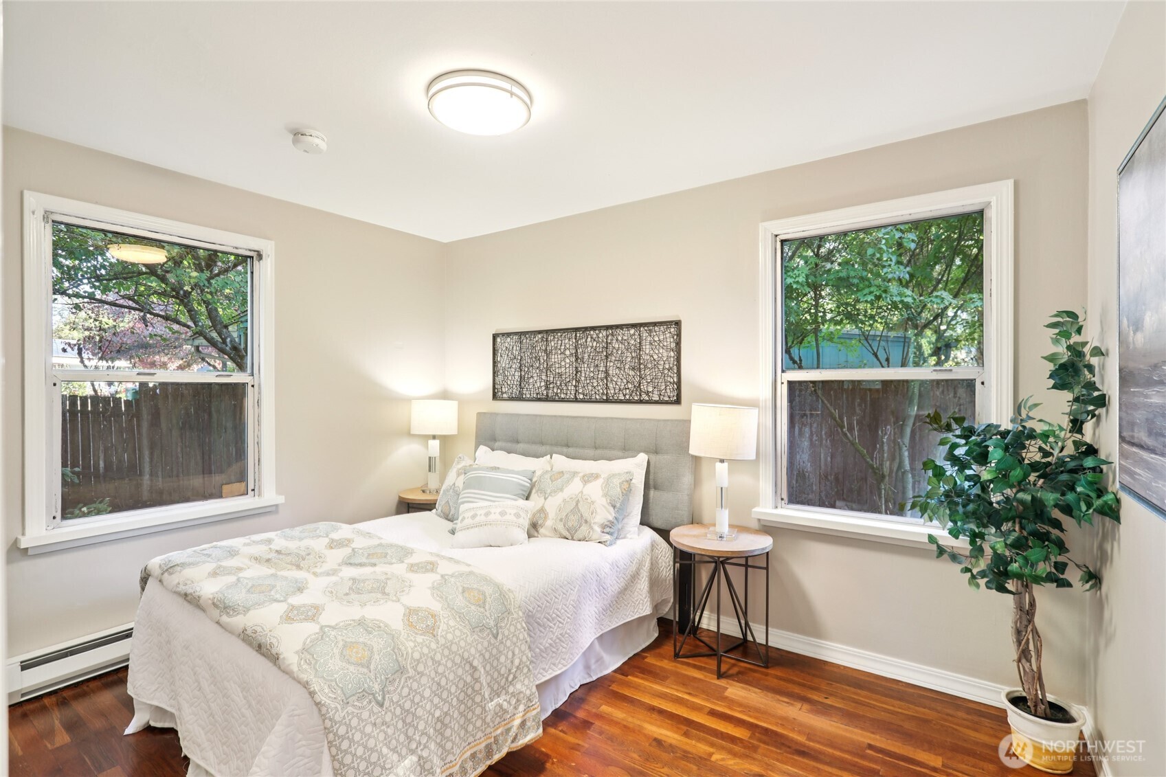1005 Northeast 170th Street Shoreline, WA 98155 - Photo 12 of 35 a bedroom with a bed and a potted plant