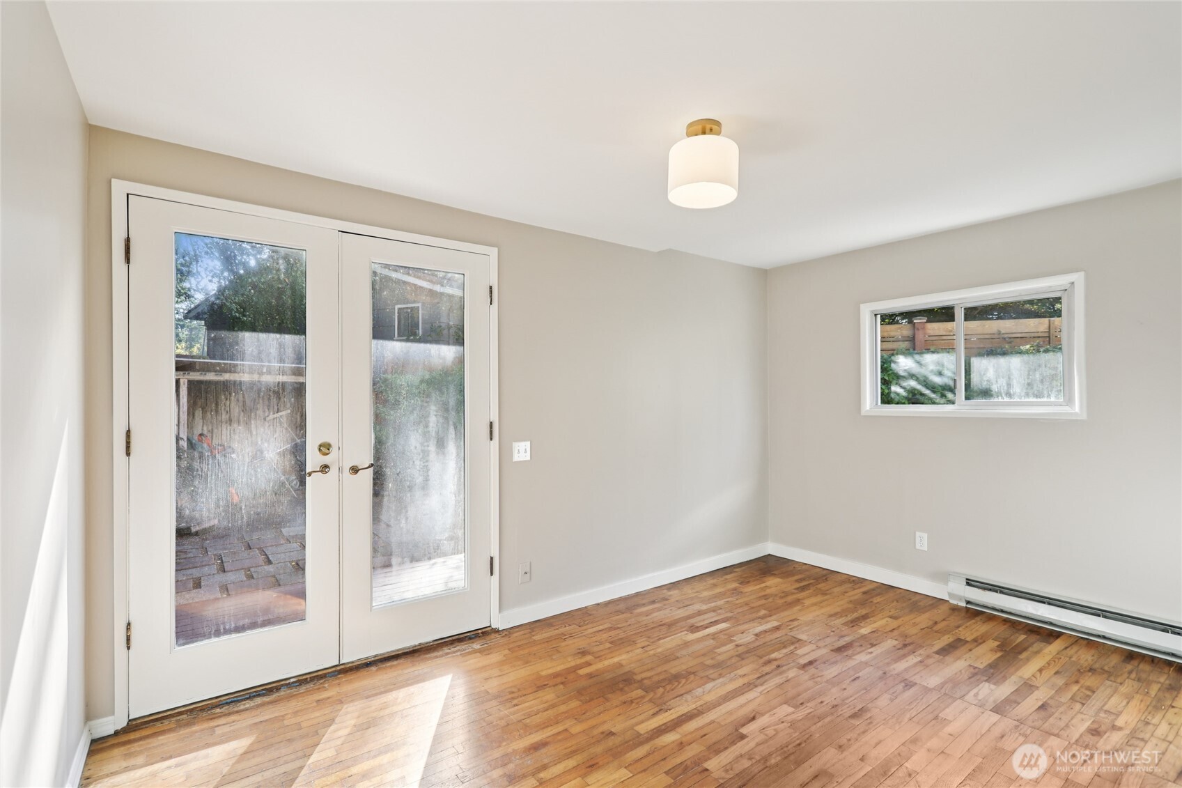 1005 Northeast 170th Street Shoreline, WA 98155 - Photo 15 of 35 a view of empty room with wooden floor and fan