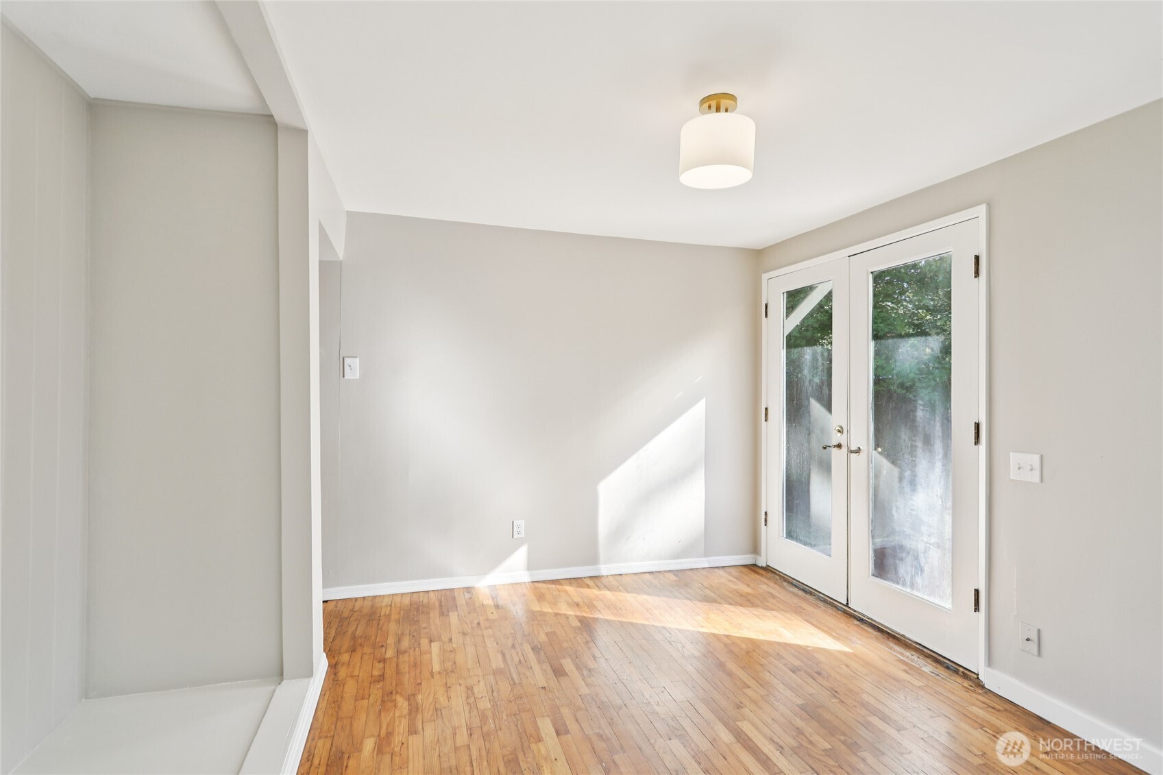 1005 Northeast 170th Street Shoreline, WA 98155 - Photo 16 of 35 a view of empty room with wooden floor and fan