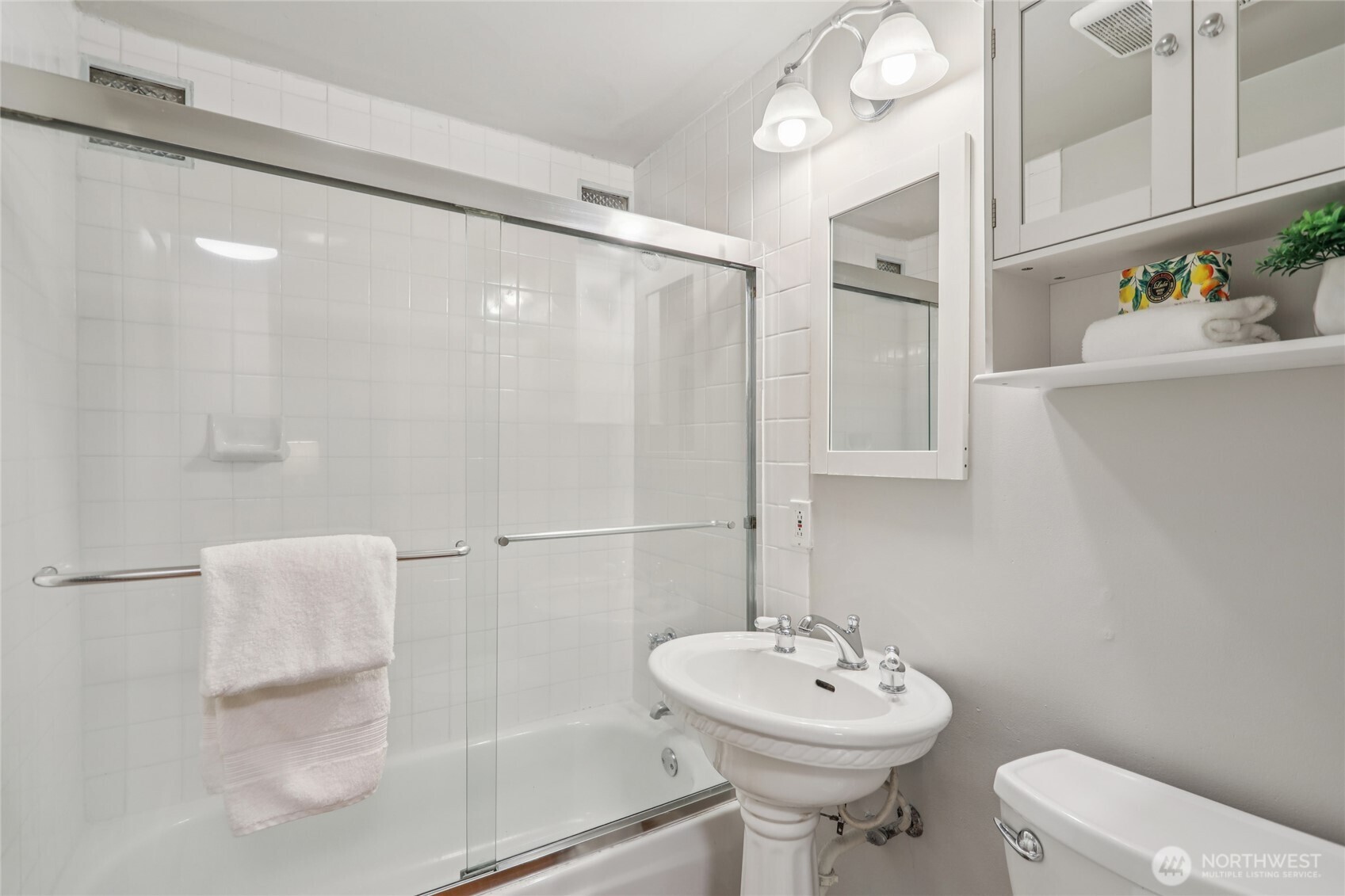 1005 Northeast 170th Street Shoreline, WA 98155 - Photo 18 of 35 a bathroom with a sink mirror and toilet