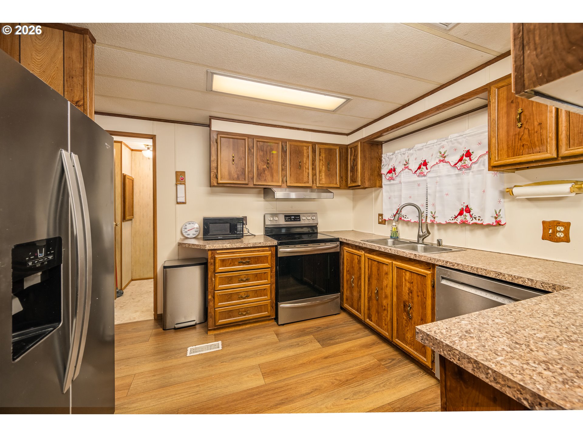 5254 Forsythia Street Springfield, OR 97478 - Photo 3 of 18 a kitchen with stainless steel appliances granite countertop a refrigerator and a sink