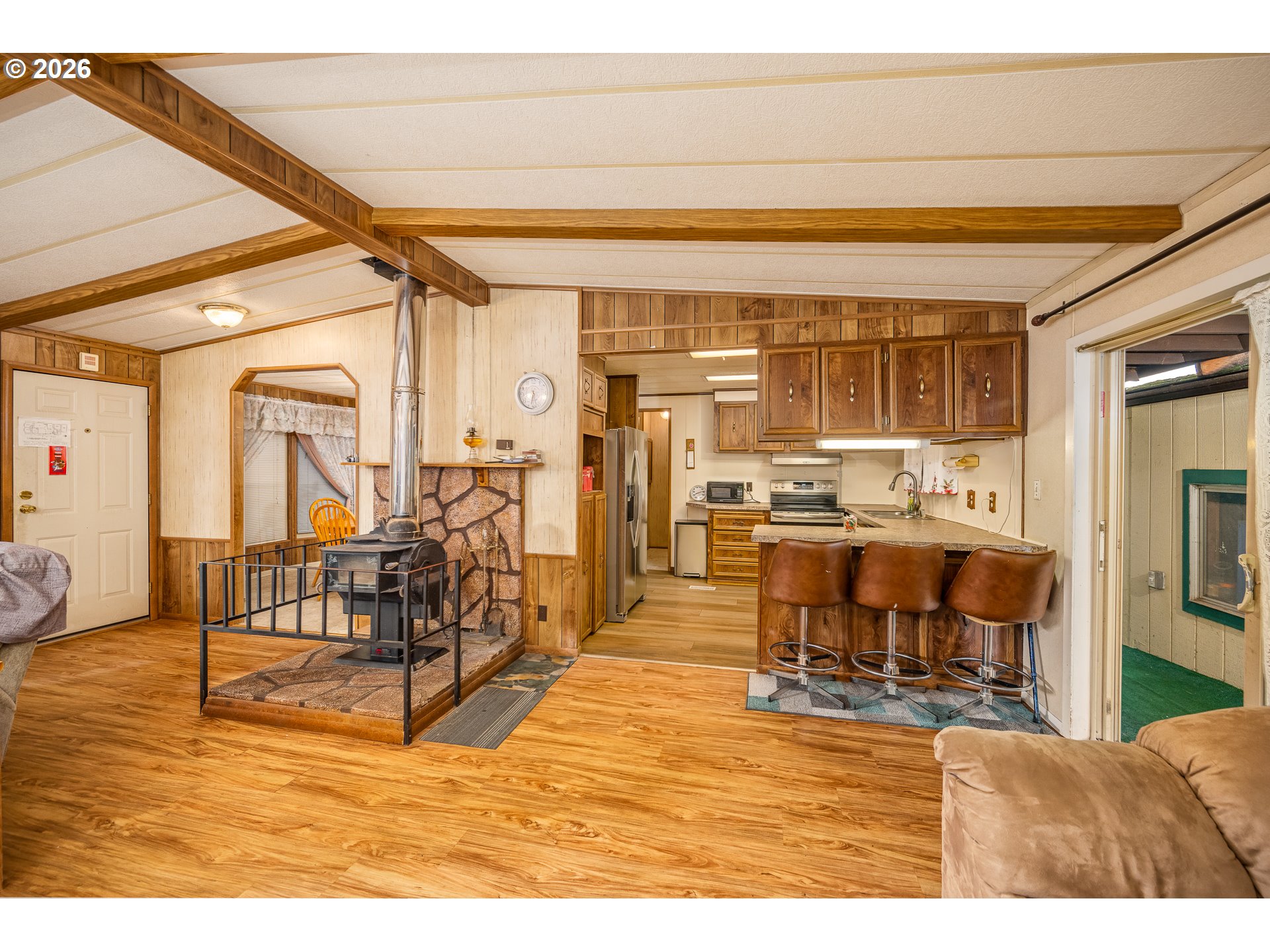 5254 Forsythia Street Springfield, OR 97478 - Photo 4 of 18 a living room with fireplace furniture and a dining table