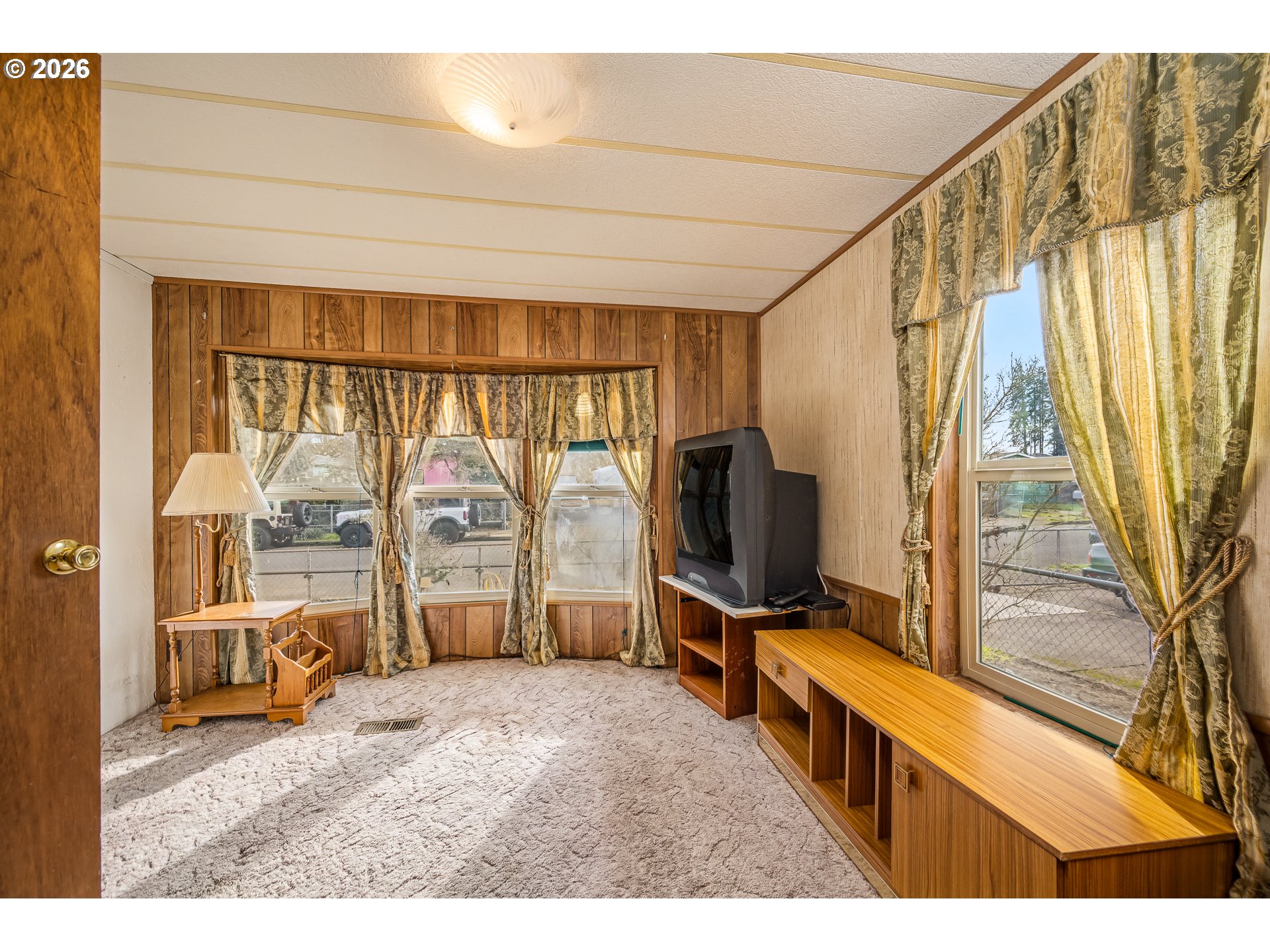 5254 Forsythia Street Springfield, OR 97478 - Photo 9 of 18 a living room with a large window and a flat screen tv