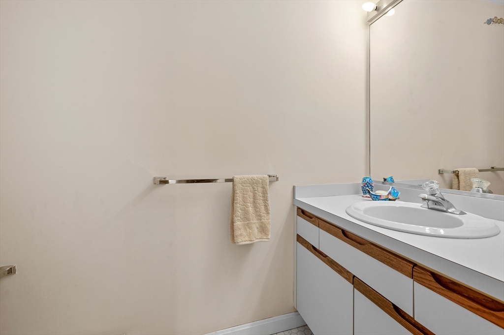 72 Chestnut Circle, Unit 72 Brewster, MA 02631 - Photo 12 of 28 a bathroom with a sink and mirror