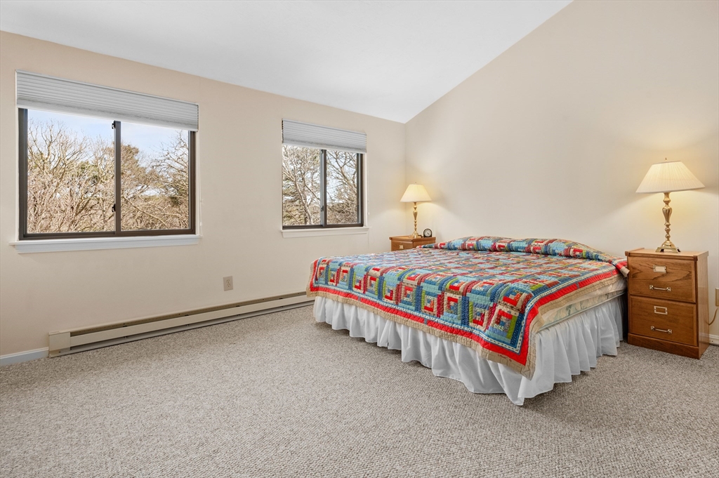 72 Chestnut Circle, Unit 72 Brewster, MA 02631 - Photo 18 of 28 a bedroom with a bed lamp and a window
