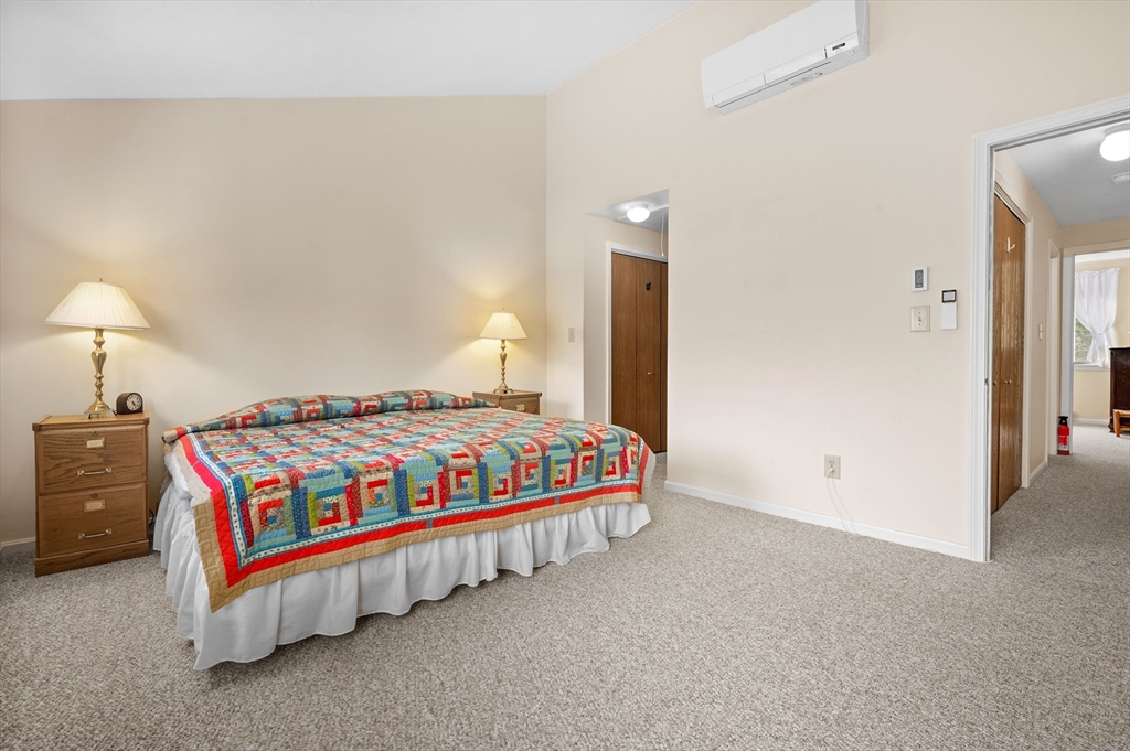 72 Chestnut Circle, Unit 72 Brewster, MA 02631 - Photo 19 of 28 a bedroom with a bed and a night stand