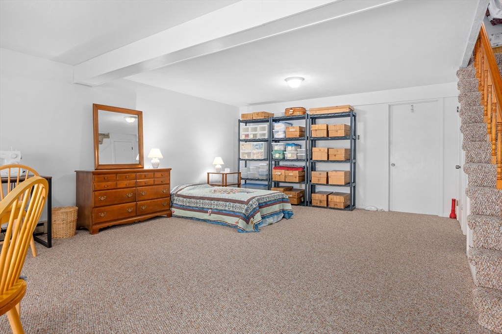 72 Chestnut Circle, Unit 72 Brewster, MA 02631 - Photo 21 of 28 a bedroom with furniture and a book shelf