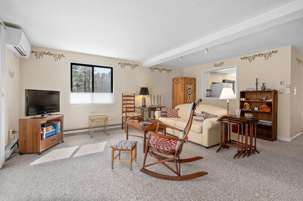 72 Chestnut Circle, Unit 72 Brewster, MA 02631 - Photo 10 of 28 a living room with furniture and a flat screen tv