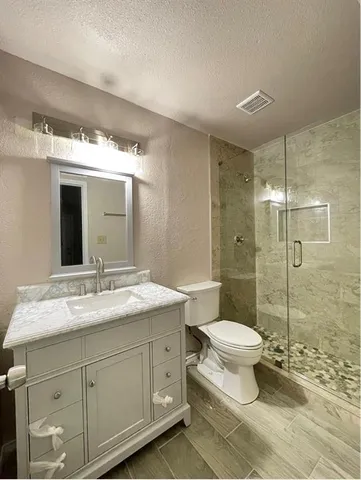 a bathroom with a sink toilet and shower