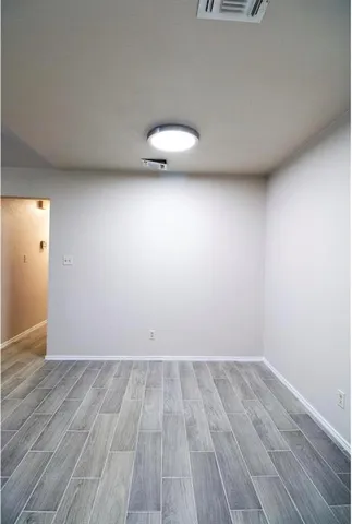 a view of a room with wooden floor