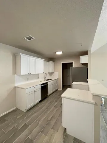 a kitchen that has a sink and a stove in it