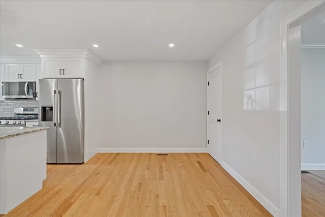 a view of a kitchen with a sink and a refrigerator