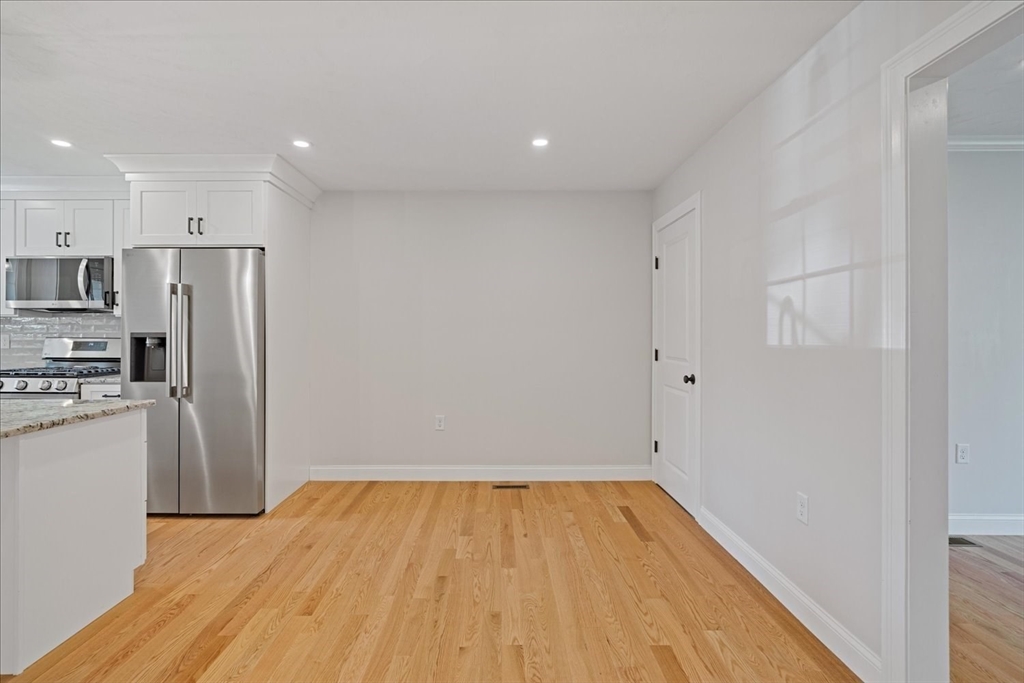 511 Mendon Road, Unit 511 Attleboro, MA 02703 - Photo 11 of 37 a view of a kitchen with a sink and a refrigerator