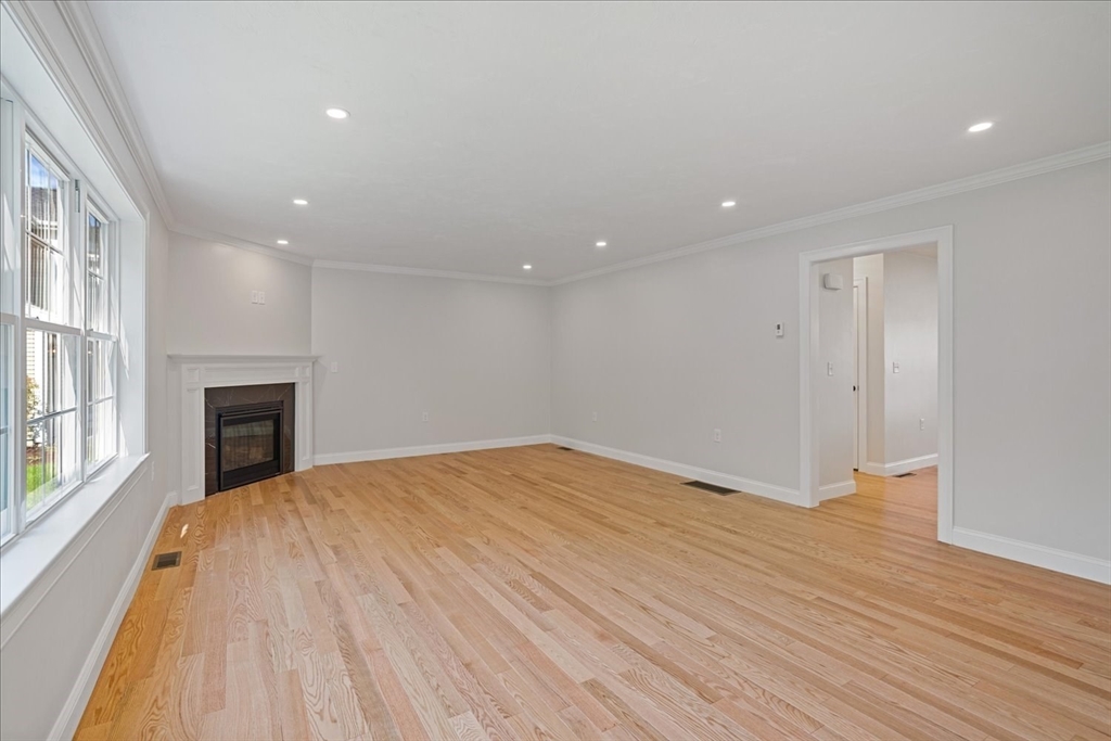 511 Mendon Road, Unit 511 Attleboro, MA 02703 - Photo 12 of 37 a view of an empty room with wooden floor and a window