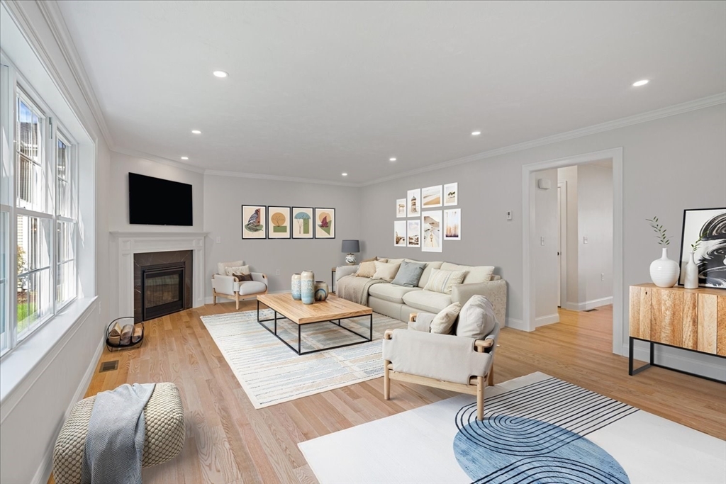 511 Mendon Road, Unit 511 Attleboro, MA 02703 - Photo 13 of 37 a living room with furniture a fireplace and a flat screen tv