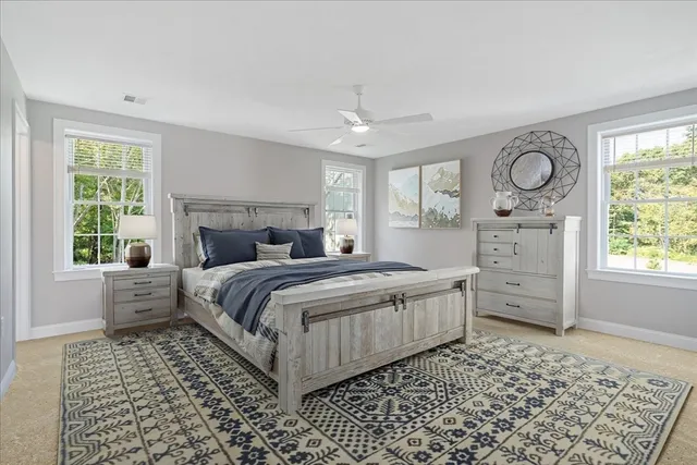 a bedroom with a large bed and a window