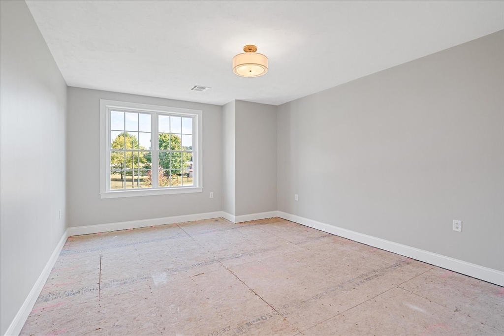 511 Mendon Road, Unit 511 Attleboro, MA 02703 - Photo 20 of 37 an empty room with windows and with ceiling fan