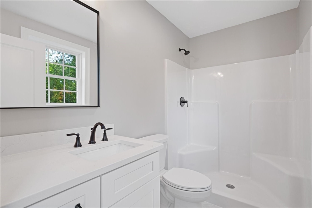 511 Mendon Road, Unit 511 Attleboro, MA 02703 - Photo 23 of 37 a bathroom with a sink a toilet and shower
