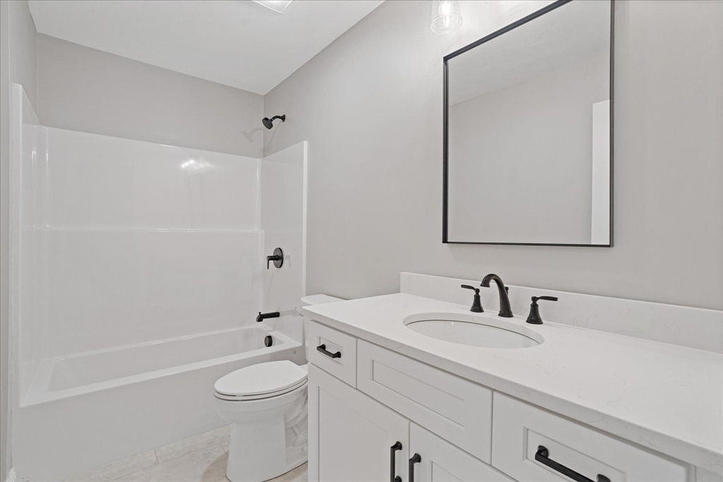 511 Mendon Road, Unit 511 Attleboro, MA 02703 - Photo 28 of 37 a bathroom with a sink a toilet and shower