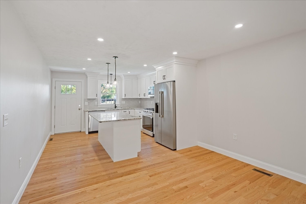511 Mendon Road, Unit 511 Attleboro, MA 02703 - Photo 9 of 37 a kitchen with a refrigerator sink and wooden floor