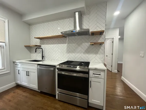 a kitchen with stainless steel appliances granite countertop a stove and a sink