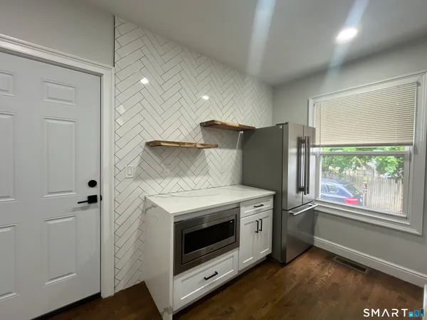 a kitchen with a stove and a refrigerator