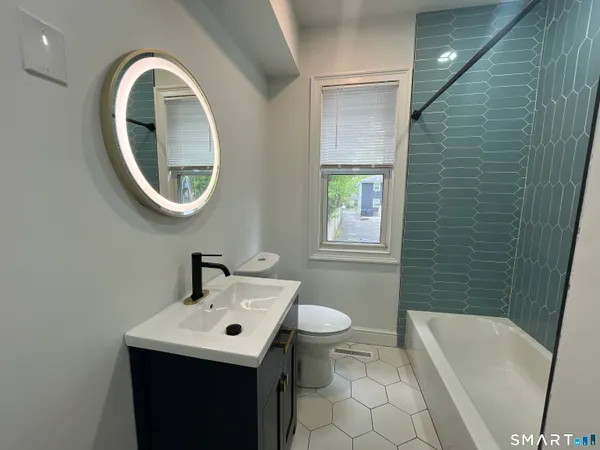 a bathroom with a sink a toilet and bathtub