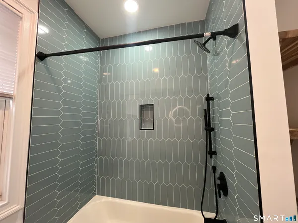 a bathroom with a shower and a toilet