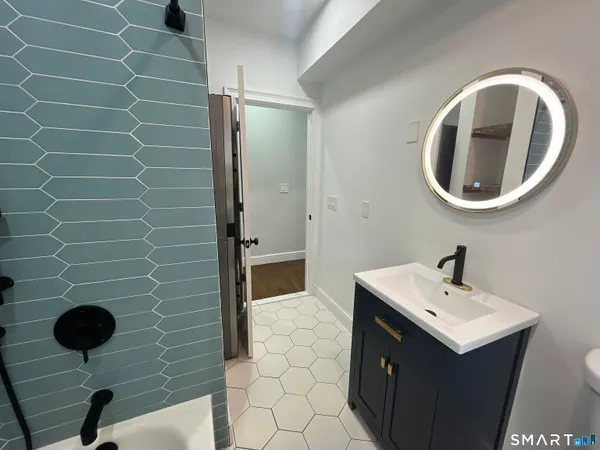 a bathroom with a sink mirror vanity and toilet