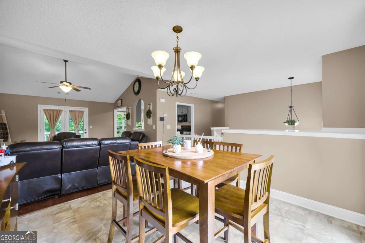 335 Elizabeth Court Colbert, GA 30628 - Photo 8 of 33 a view of a dining room with furniture a chandelier and wooden floor