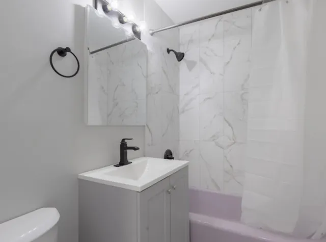 a bathroom with a sink toilet and shower