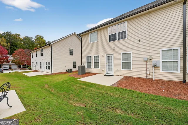a backyard of a house with table and chairs