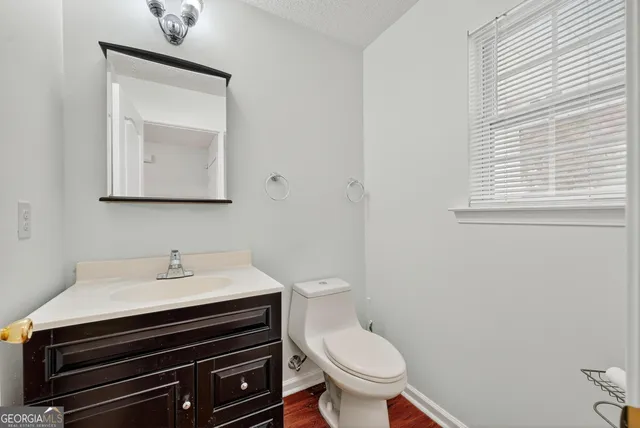 a bathroom with a toilet sink and mirror