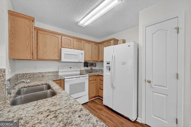 a kitchen with a refrigerator sink and stove