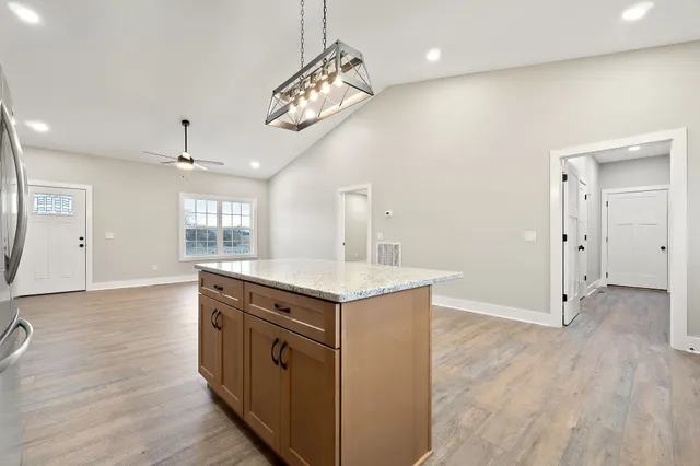 a kitchen with a stove and a wooden floors