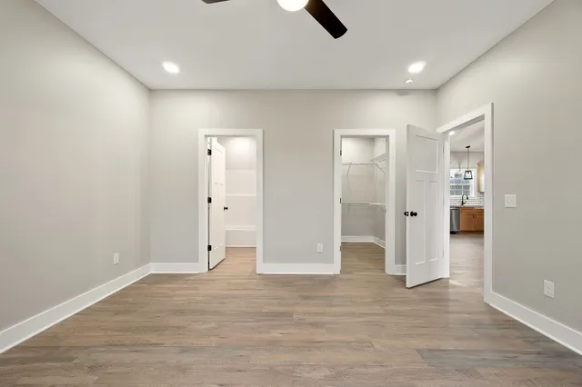 wooden floor in an empty room with a bathroom