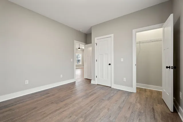 a view of an empty room and wooden floor