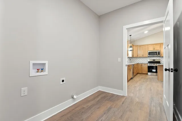 a view of a kitchen with wooden floor and a sink