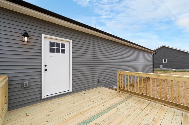 a view of a house with wooden deck