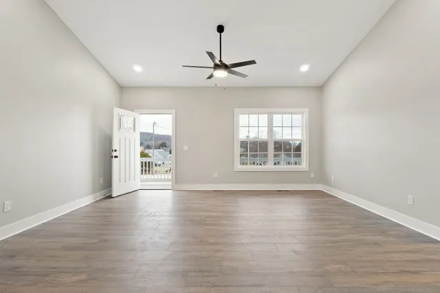wooden floor in an empty room with a window