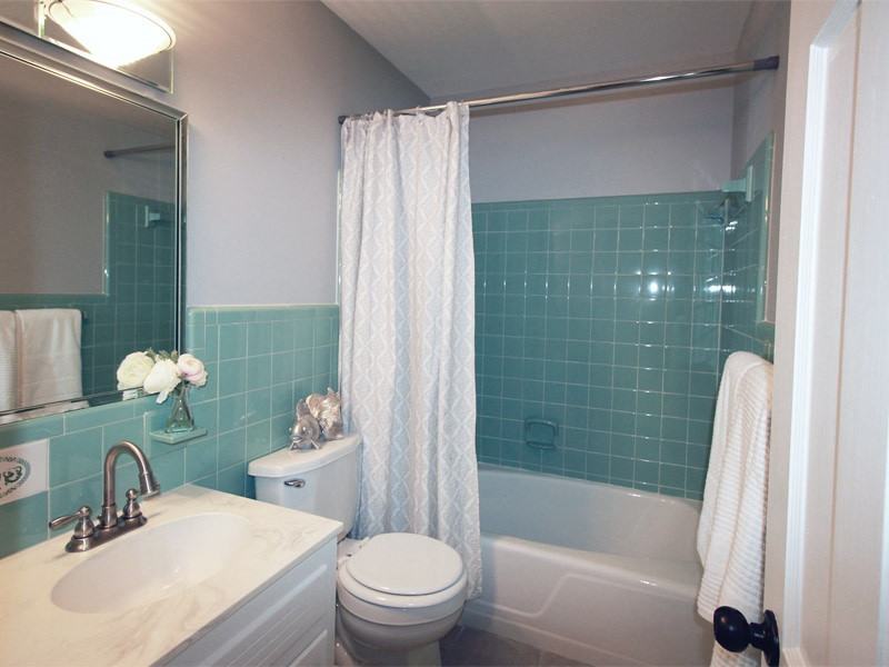 308 Lord Berkley Road Raleigh, NC 27610 - Photo 20 of 25 This bathroom is FABULOUS! The showcase being the original seafoam green tile that the owner thought was just too pretty to smash up! Instead, the bathroom has been updated with brand new tile flooring, soft gray walls, and a brand new LED faucet. Guest Bathroom