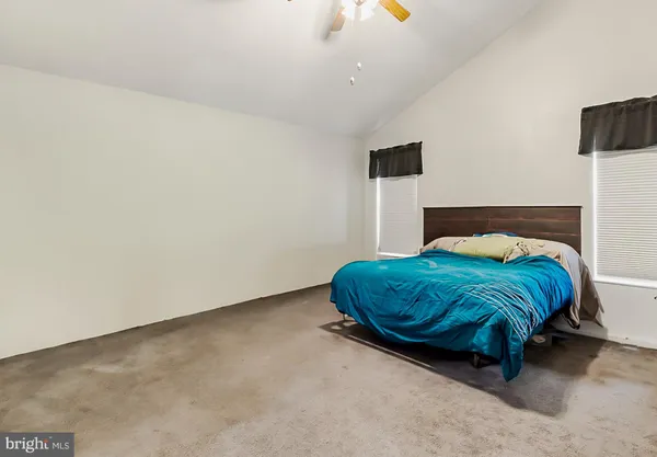 a bedroom with a bed and chair