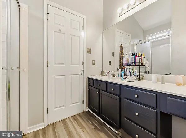 a spacious bathroom with a double vanity sink and mirror
