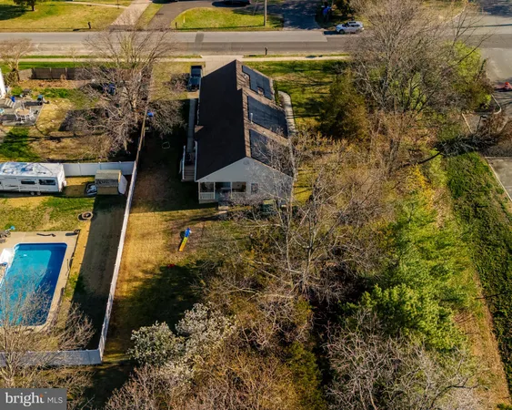 an aerial view of a house with garden space and street view