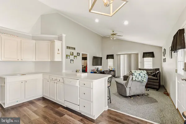 a large white kitchen with stainless steel appliances
