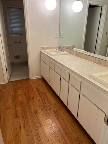 a spacious bathroom with a sink and a mirror
