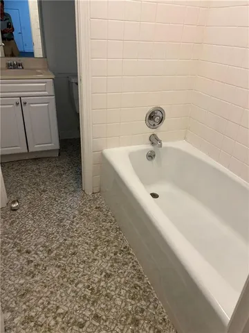 a bathroom with a bathtub and sink