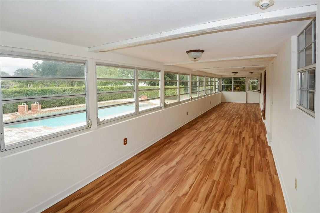 13851 Stirling Road Southwest Ranches, FL 33330 - Photo 13 of 33 a view of an empty room with wooden floor and windows